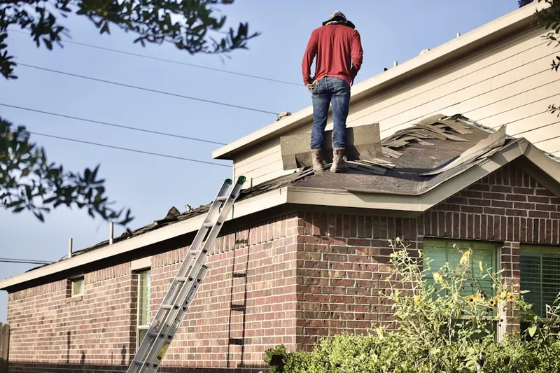 Professional roofer working on a residential roof in North Duxbury